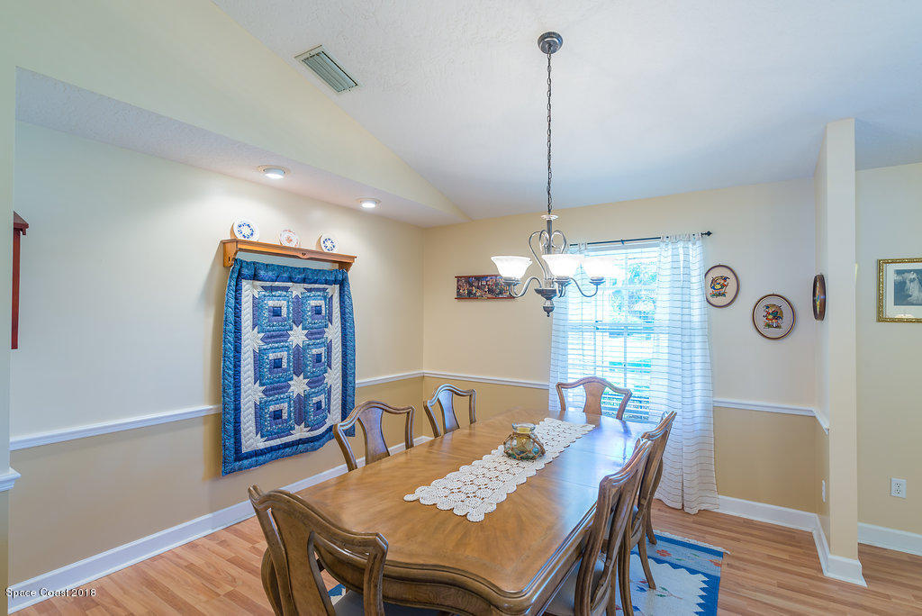 3956 Sparrow Hawk Road Melbourne, FL 32934 - Photo 8 of 34 a view of a dining room with furniture window and wooden floor