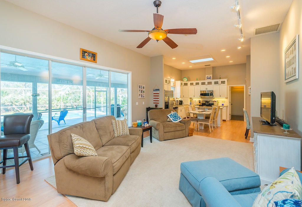 3956 Sparrow Hawk Road Melbourne, FL 32934 - Photo 10 of 34 a living room with furniture ceiling fan and a flat screen tv