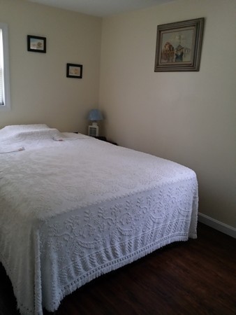 5 Thompson Road, Unit A Bourne, MA 02532 - Photo 4 of 13 a bedroom with a bed and wooden floor