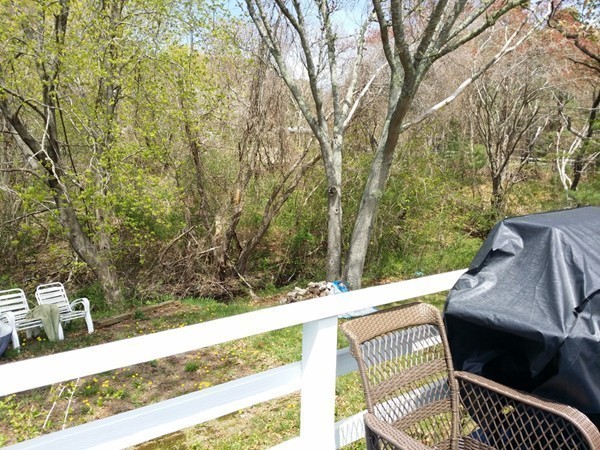 5 Thompson Road, Unit A Bourne, MA 02532 - Photo 8 of 13 a view of a deck with couches and wooden fence