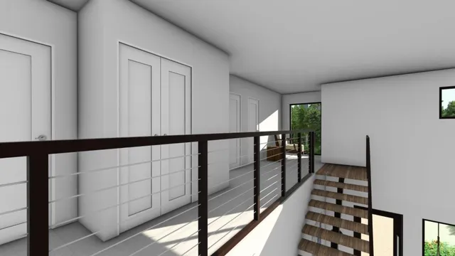 a view of staircase with lots of frames on wall and a window