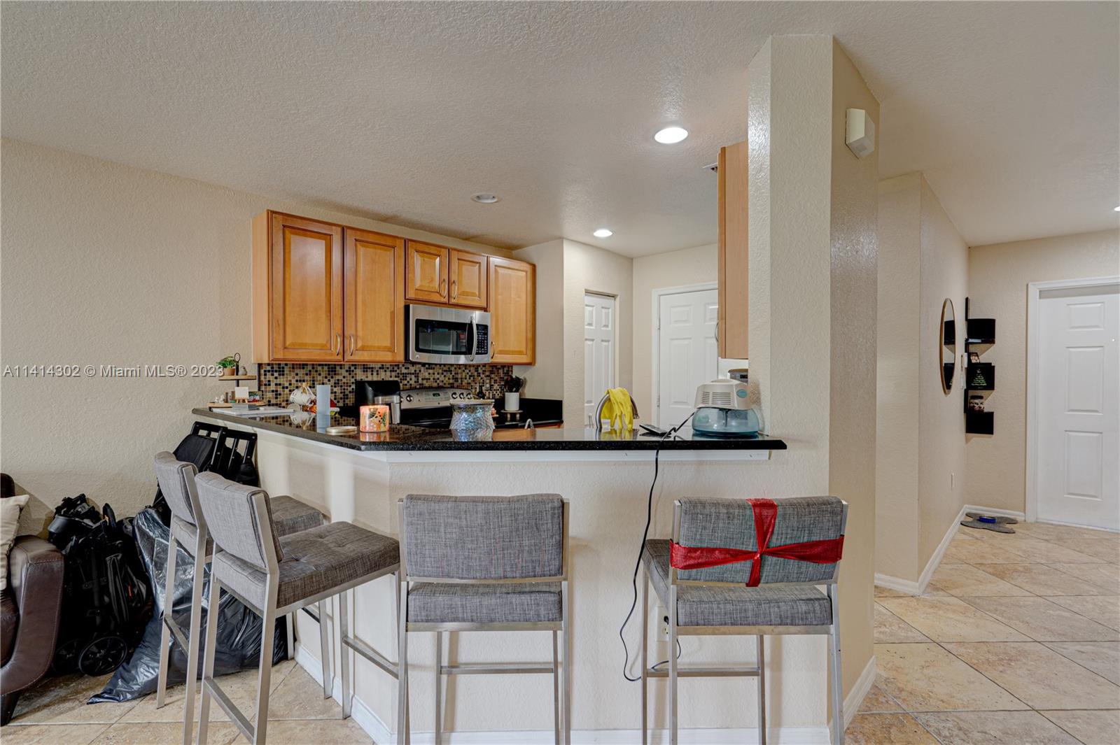 5894 Abbey Road Tamarac, FL 33321 - Photo 13 of 48 a living room with stainless steel appliances kitchen island granite countertop furniture and a view of kitchen