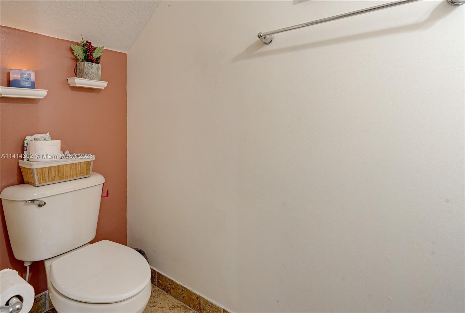 5894 Abbey Road Tamarac, FL 33321 - Photo 19 of 48 a white toilet sitting next to a white wall
