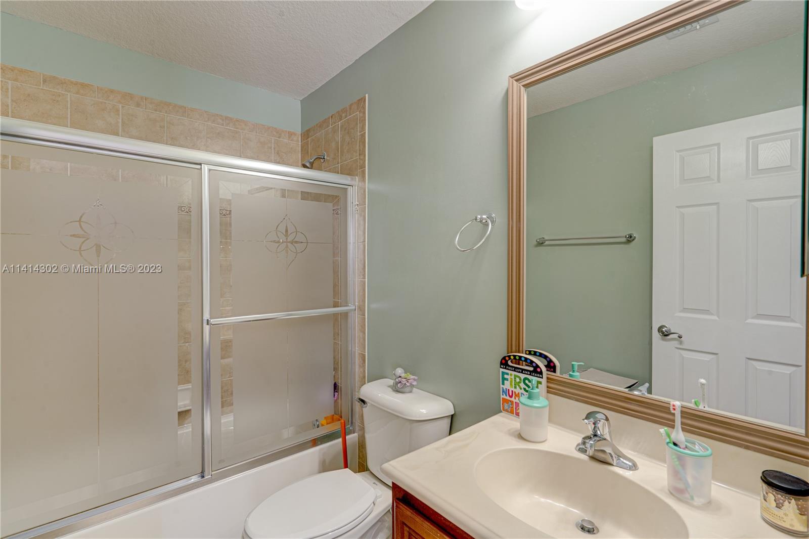 5894 Abbey Road Tamarac, FL 33321 - Photo 23 of 48 a bathroom with a sink toilet and shower