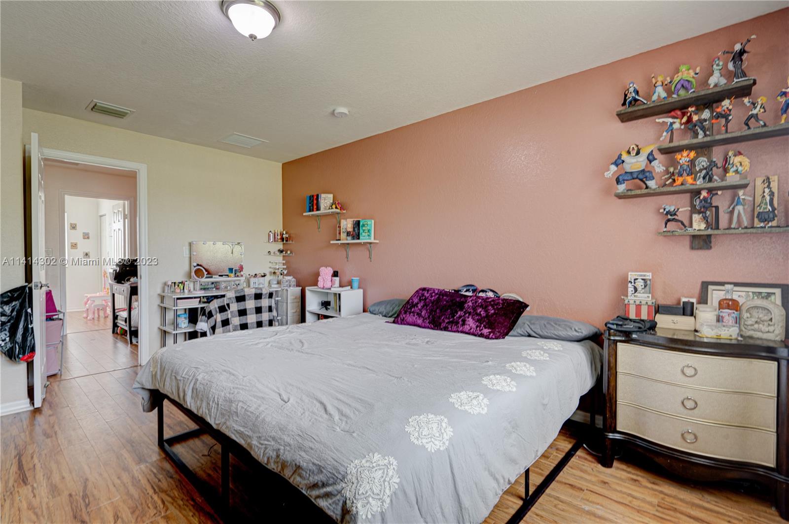 5894 Abbey Road Tamarac, FL 33321 - Photo 30 of 48 a bedroom with a bed and a table in it