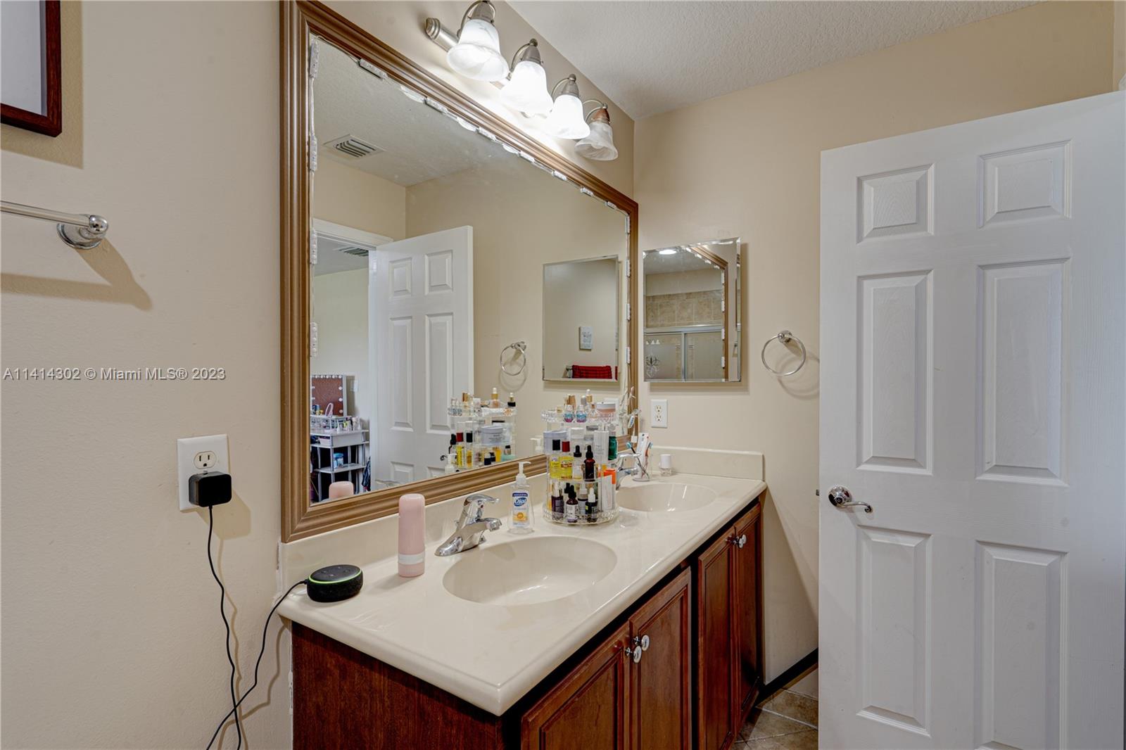 5894 Abbey Road Tamarac, FL 33321 - Photo 33 of 48 a bathroom with a sink and a mirror