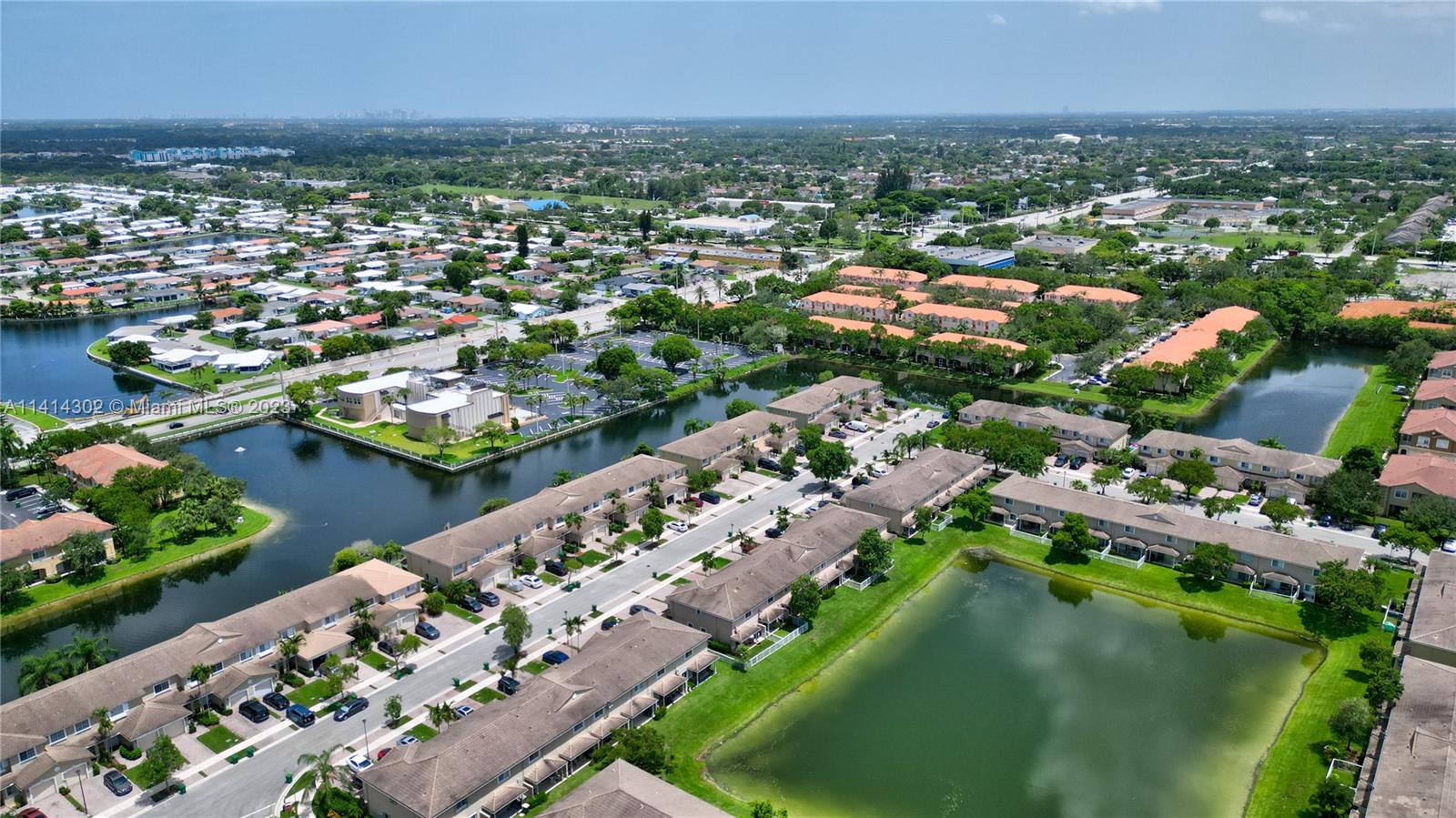 5894 Abbey Road Tamarac, FL 33321 - Photo 38 of 48 an aerial view of a city with lots of residential buildings ocean and mountain view in back