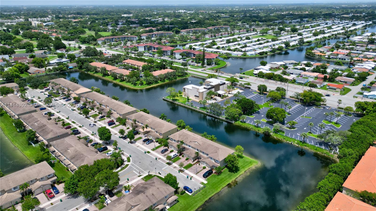 5894 Abbey Road Tamarac, FL 33321 - Photo 43 of 48 an aerial view of a city with lots of residential buildings ocean and mountain view in back