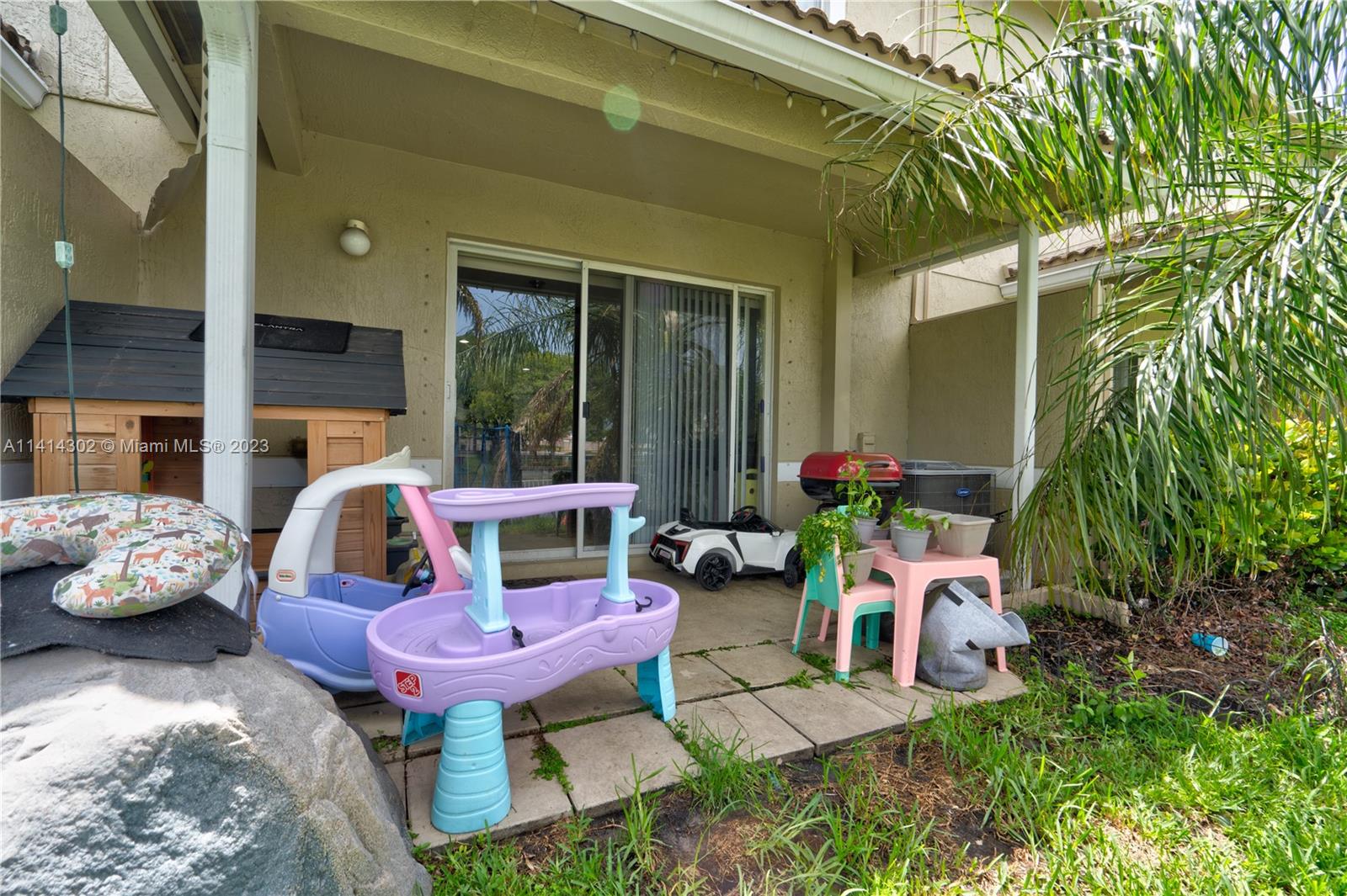 5894 Abbey Road Tamarac, FL 33321 - Photo 8 of 48 a view of a chair and table in backyard of the house
