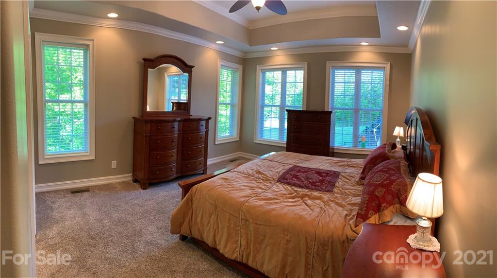 259 Beechtree Circle Rutherfordton, NC 28139 - Photo 11 of 48 a bed sitting in a spacious bedroom next to a window and dresser