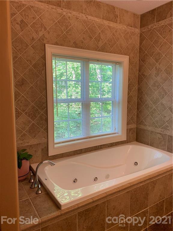 259 Beechtree Circle Rutherfordton, NC 28139 - Photo 14 of 48 a bathroom with a bathtub and window