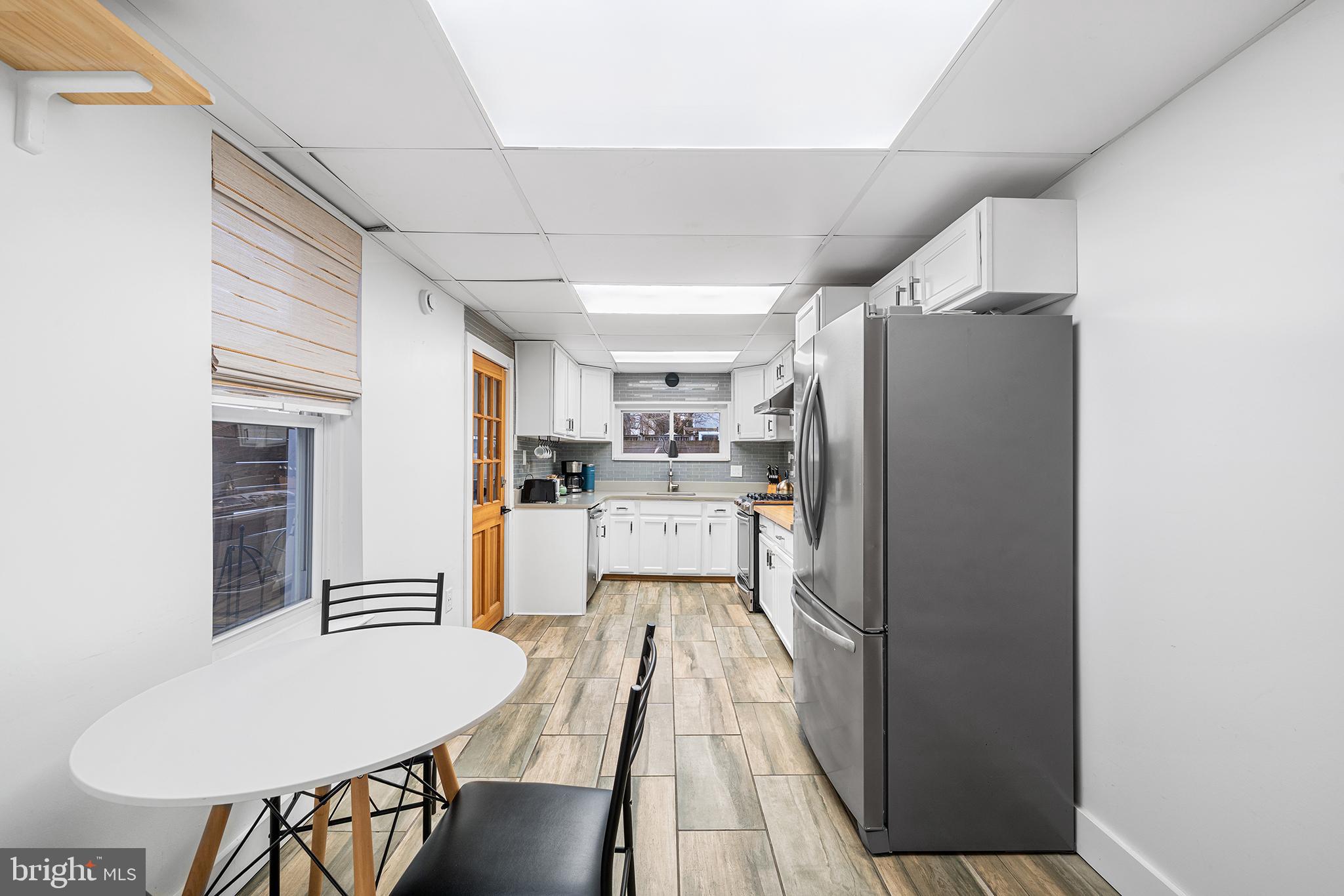 2425 Sepviva Street Philadelphia, PA 19125 - Photo 12 of 34 a kitchen with refrigerator and chairs