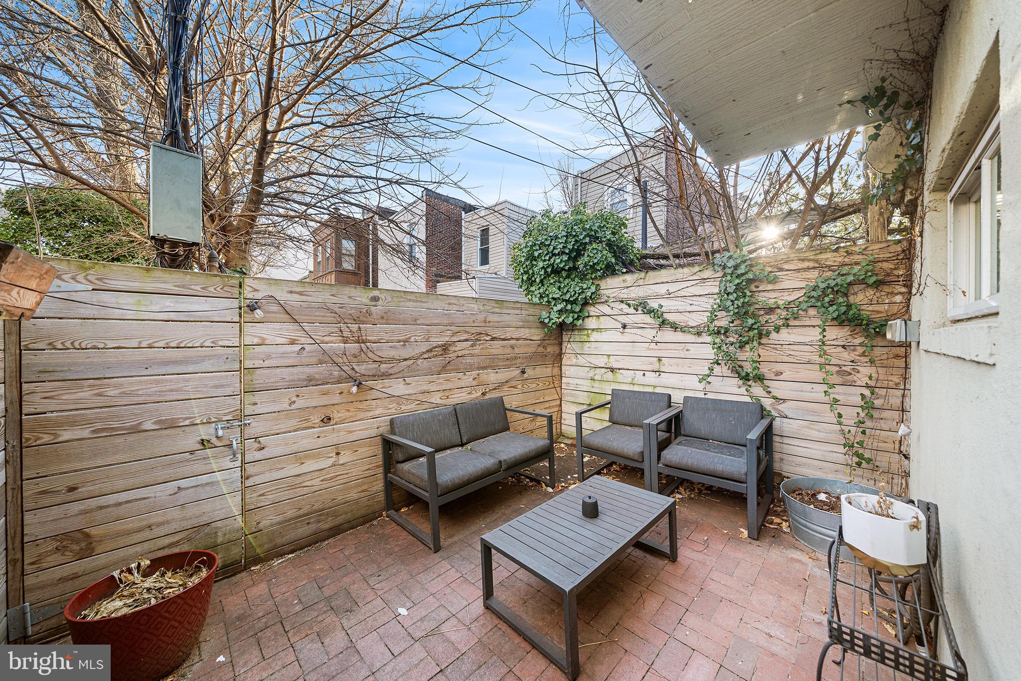 2425 Sepviva Street Philadelphia, PA 19125 - Photo 14 of 34 a backyard of a house with sofas fire pit and outdoor seating