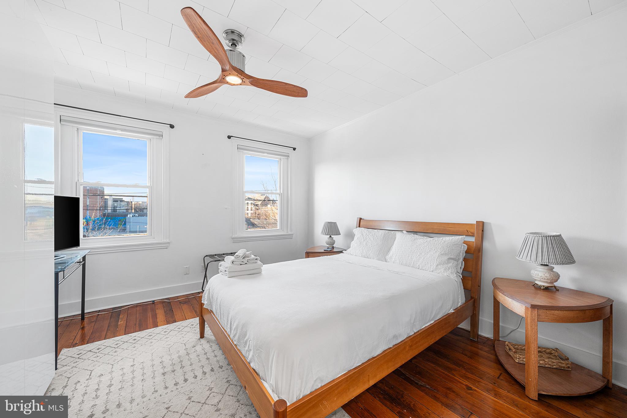 2425 Sepviva Street Philadelphia, PA 19125 - Photo 19 of 34 a bedroom with a bed and a table in it