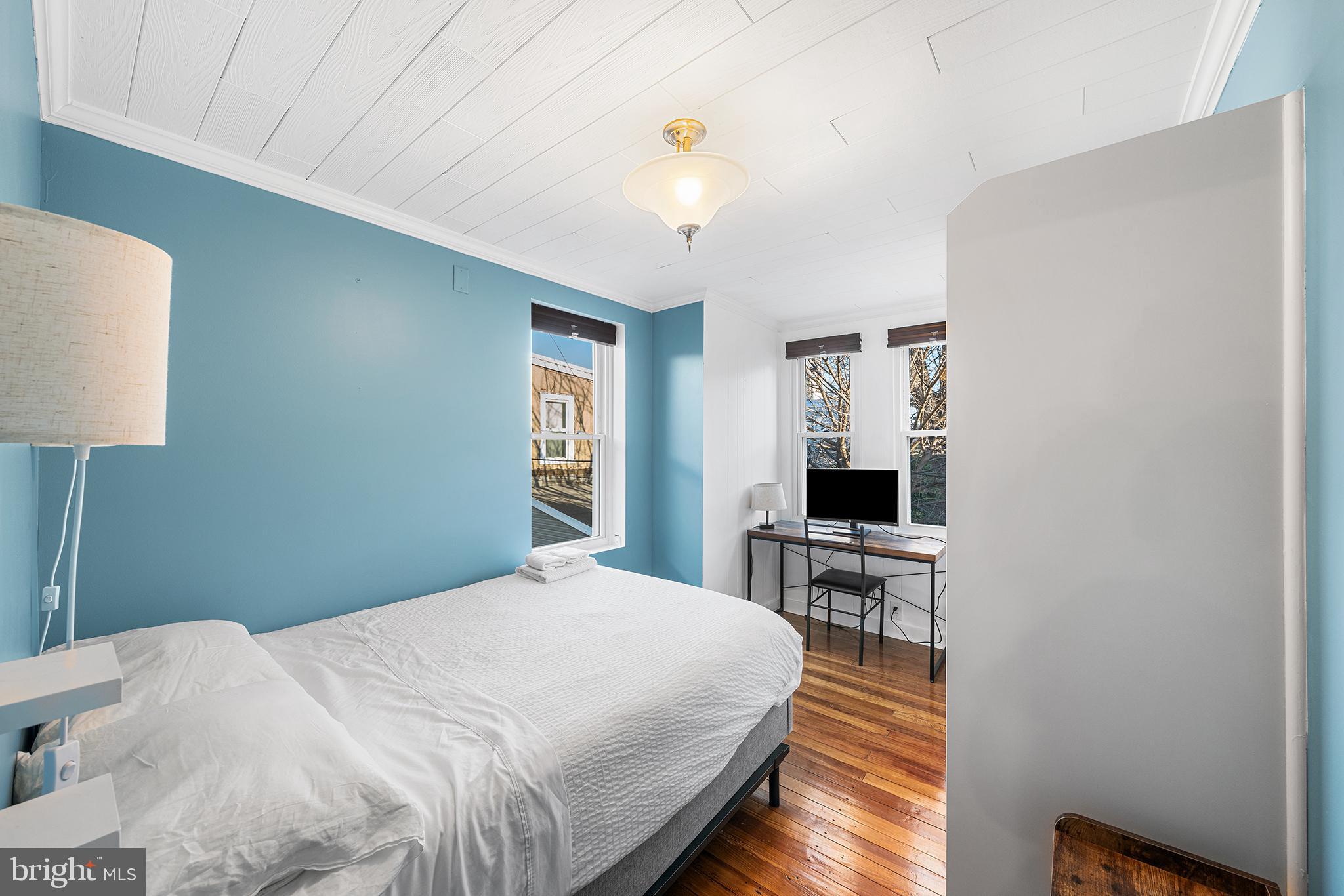 2425 Sepviva Street Philadelphia, PA 19125 - Photo 23 of 34 a bedroom with a bed and a table lamp