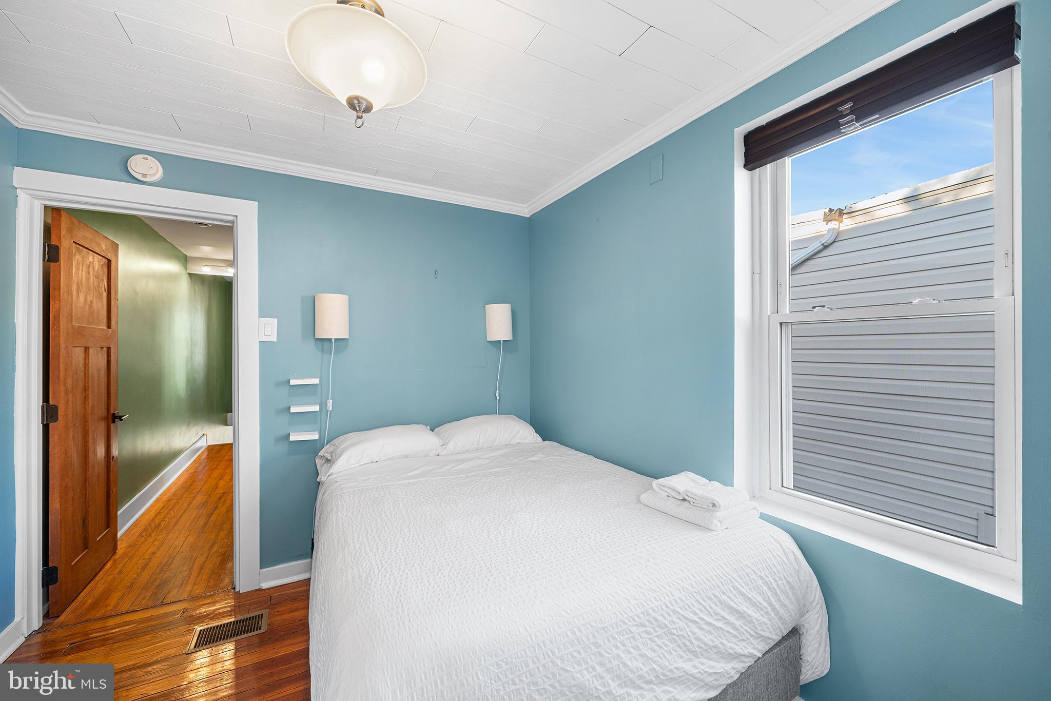 2425 Sepviva Street Philadelphia, PA 19125 - Photo 25 of 34 a bedroom with a bed and a chandelier