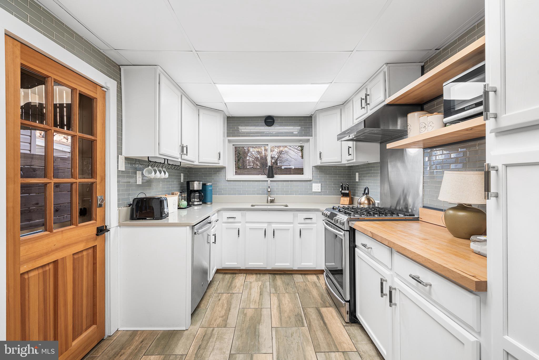 2425 Sepviva Street Philadelphia, PA 19125 - Photo 10 of 34 a kitchen with stainless steel appliances granite countertop a stove and a refrigerator