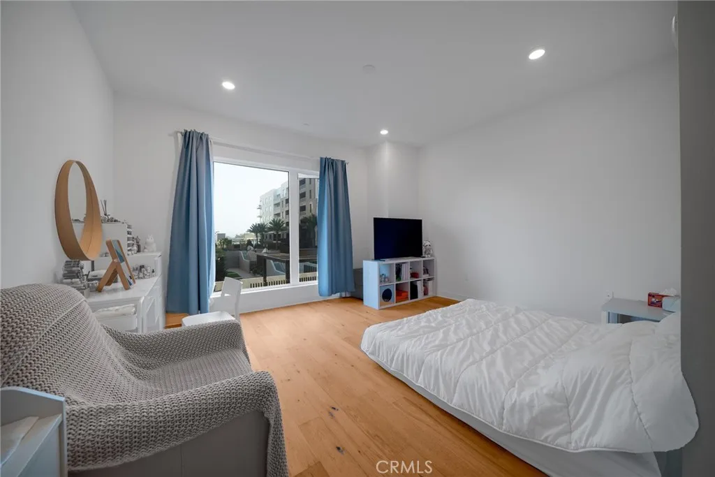 1310 Rivington Irvine, CA 92606 - Photo 11 of 20 a bedroom with a bed a couch and a flat tv screen on the dresser