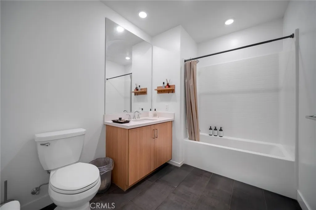 1310 Rivington Irvine, CA 92606 - Photo 4 of 20 a bathroom with a granite countertop sink toilet and shower