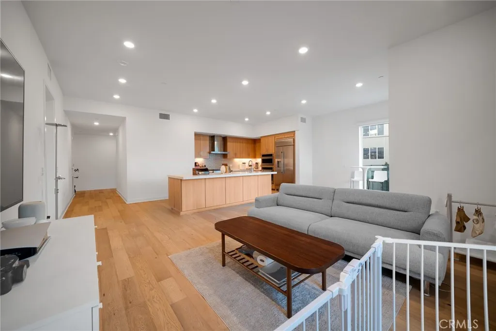 1310 Rivington Irvine, CA 92606 - Photo 10 of 20 a living room with furniture and a dining table with wooden floor