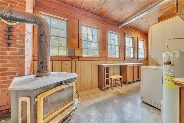 a hallway with furniture and a refrigerator