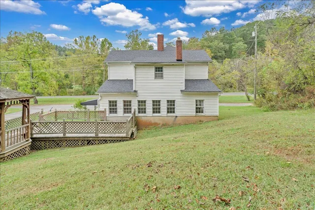 a view of a house with a yard and sitting area
