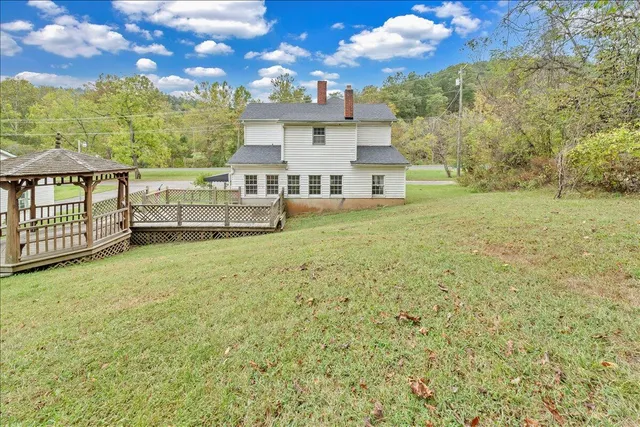 a front view of a house with a garden and yard