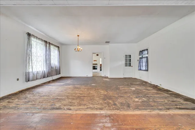 a view of empty room with closet and windows