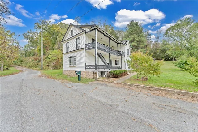 a view of a house with a yard and garage