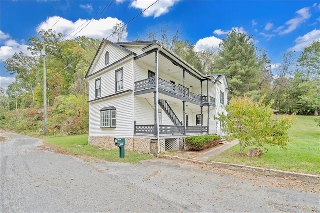 a view of a house with a yard and garage
