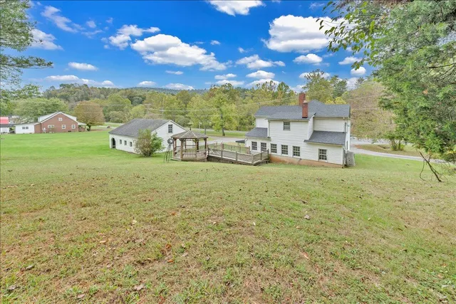 a view of a house with a yard and garage