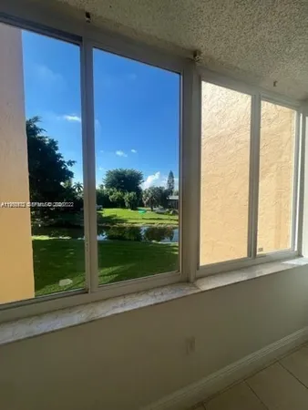 a view of a glass door and a yard from a window