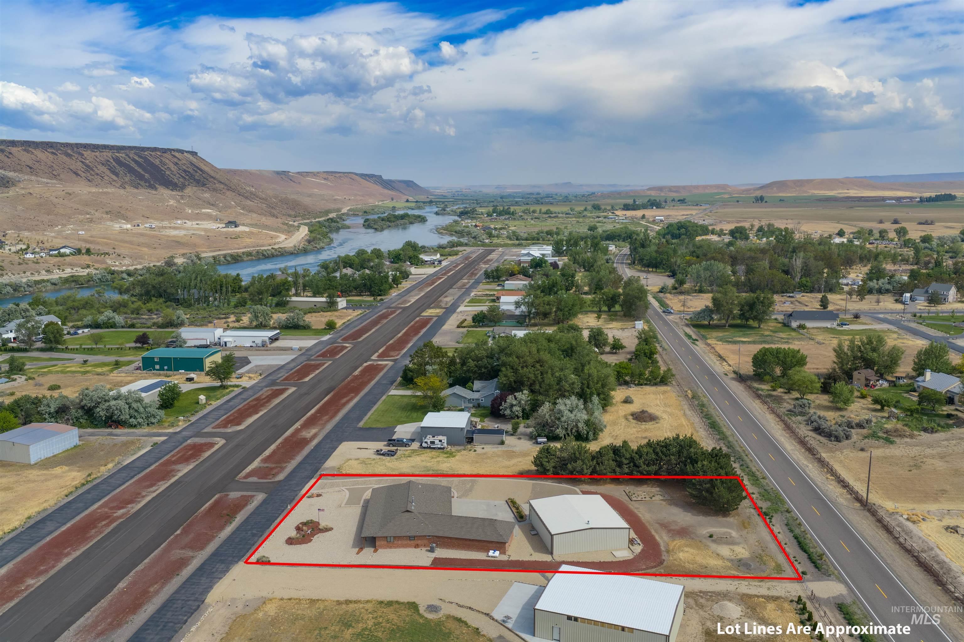 10514 Airpark Loop Road Melba, ID 83641 - Photo 2 of 47 Aerial property overview featuring a single-story structure with an attached garage, a separate large metal outbuilding, and a paved driveway