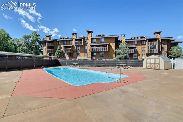 a view of a swimming pool with an outdoor seating