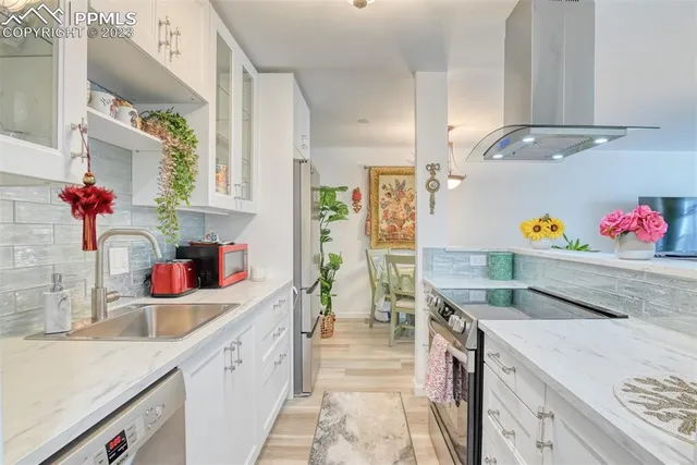 a kitchen with granite countertop a sink stove and cabinets