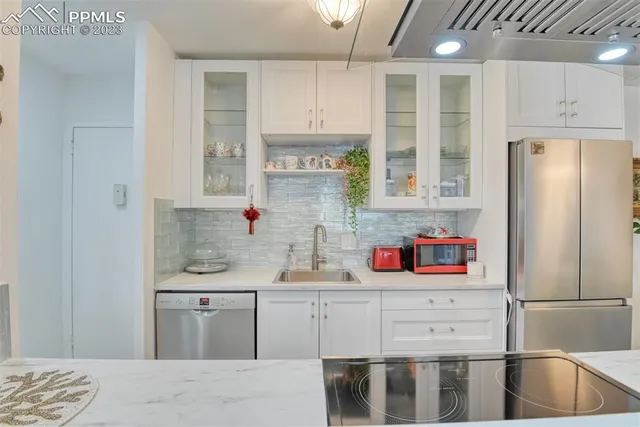a kitchen with stainless steel appliances granite countertop a refrigerator sink and cabinets