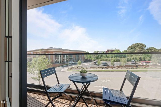 a view of a dinning table and chairs on roof deck