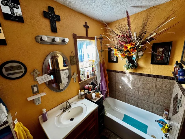 a bathroom with a sink mirror and vanity