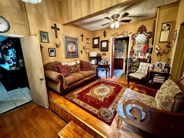 a living room with patio furniture and wooden floor