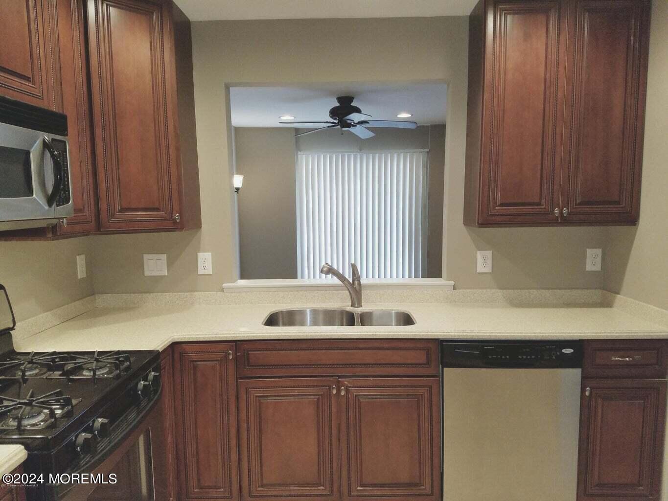150 Brookfield Drive Jackson, NJ 08527 - Photo 11 of 41 a kitchen with granite countertop a sink stainless steel appliances and cabinets