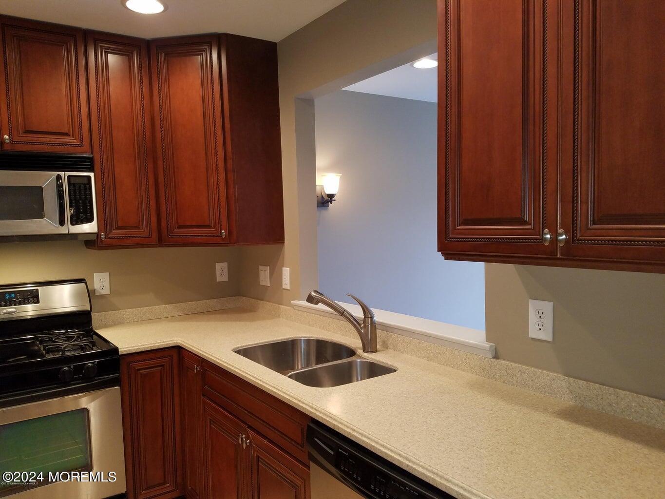 150 Brookfield Drive Jackson, NJ 08527 - Photo 12 of 41 a kitchen with granite countertop wood cabinets stainless steel appliances and a sink