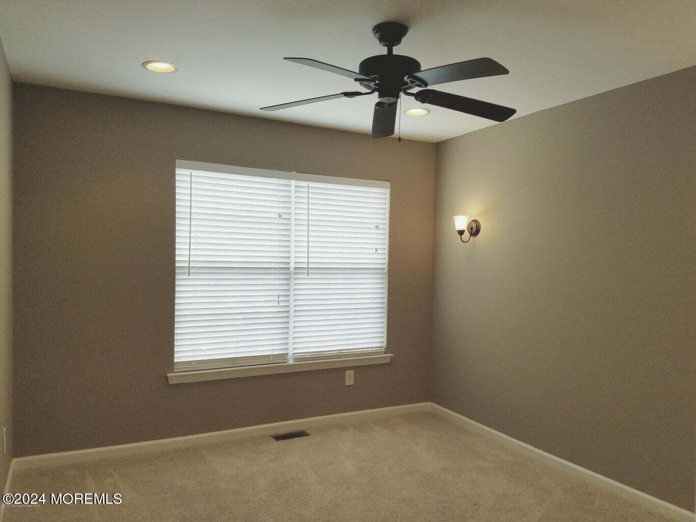 150 Brookfield Drive Jackson, NJ 08527 - Photo 22 of 41 a view of a livingroom with a ceiling fan and a window