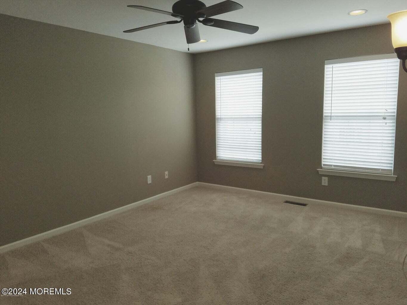 150 Brookfield Drive Jackson, NJ 08527 - Photo 28 of 41 an empty room with a window and a fan