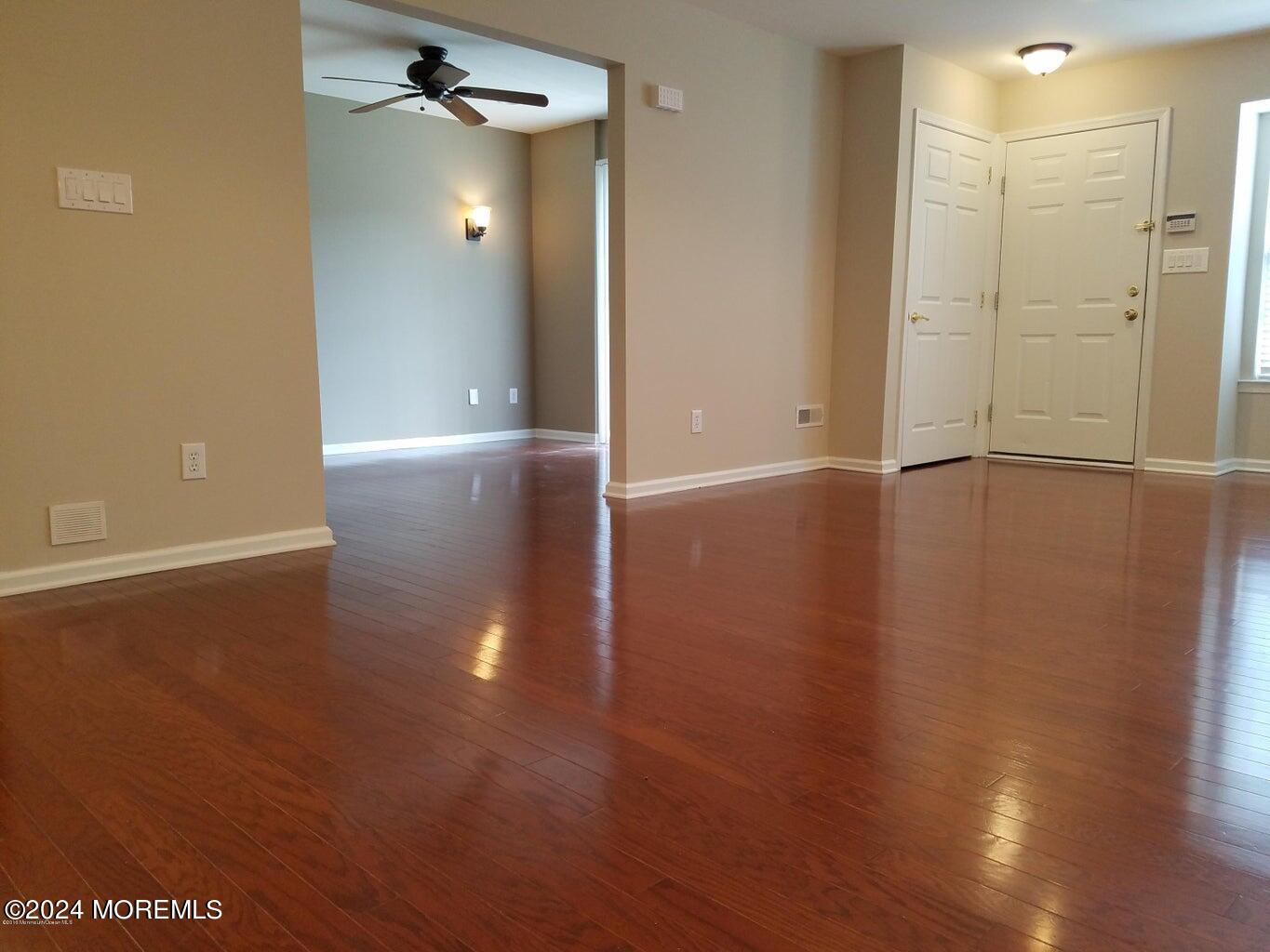150 Brookfield Drive Jackson, NJ 08527 - Photo 3 of 41 an empty room with wooden floor and mirror