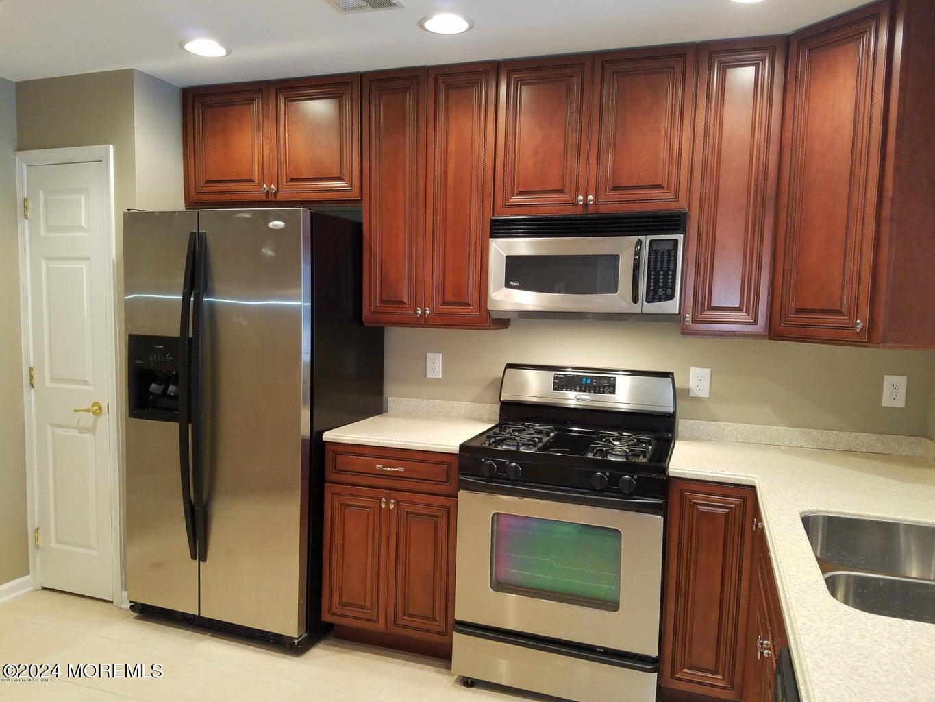 150 Brookfield Drive Jackson, NJ 08527 - Photo 8 of 41 a kitchen with granite countertop wooden cabinets and stainless steel appliances