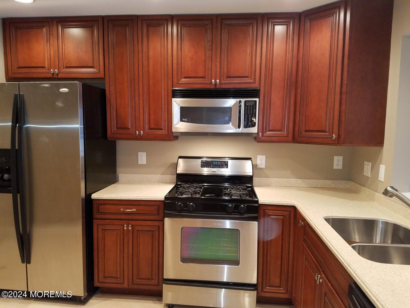 150 Brookfield Drive Jackson, NJ 08527 - Photo 9 of 41 a kitchen with granite countertop wood cabinets stainless steel appliances and a refrigerator