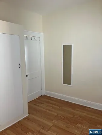 a view of a room with wooden floor and bathroom