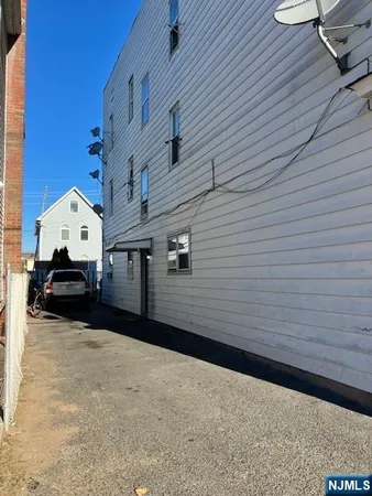 a view of a house with backyard and wooden fence