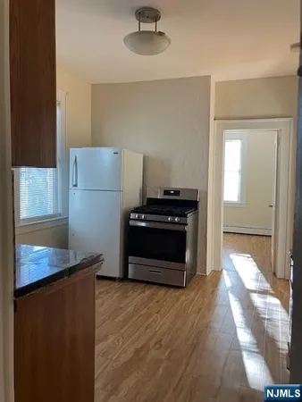 a kitchen with a refrigerator and a stove