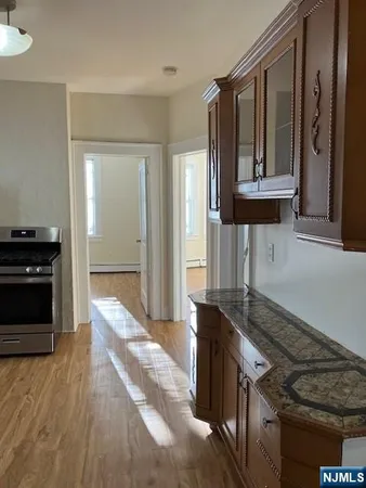 a kitchen with granite countertop a stove and a refrigerator